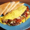 Fold in the sides of the tortilla, then roll it up tightly from the bottom, ensuring the fillings are secure inside. A little trick to avoid spillage is to make sure the tortilla is slightly overstuffed—this helps create a sturdy wrap.